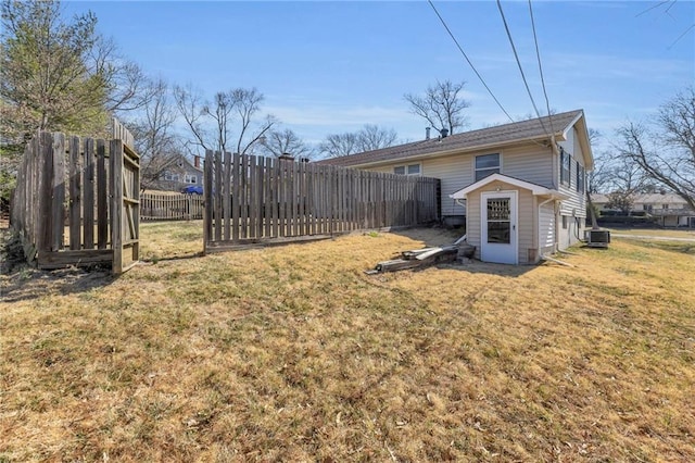 view of yard with central air condition unit and fence