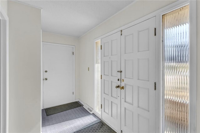 entryway with a textured ceiling