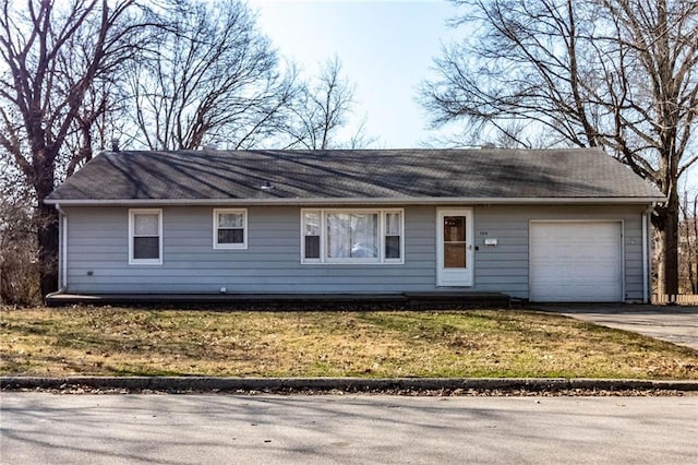 single story home with driveway, a front yard, and an attached garage