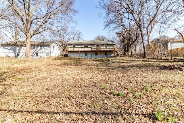 back of house with a deck