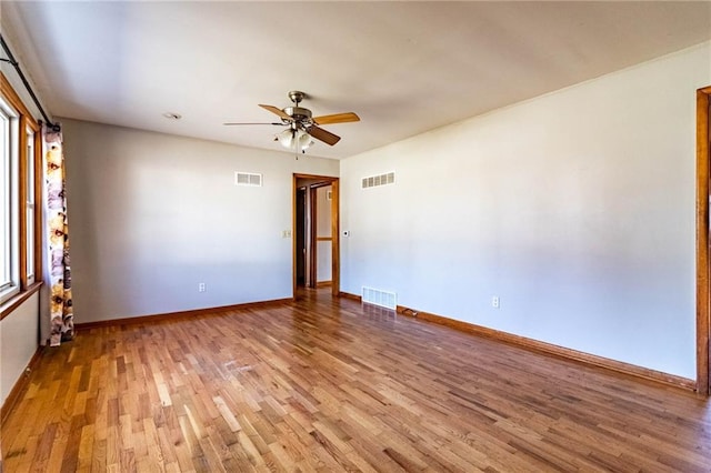 unfurnished room with visible vents and light wood finished floors