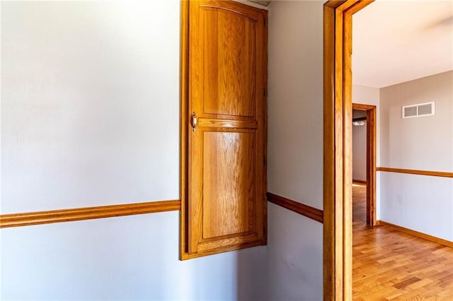 interior space with visible vents, light wood-style floors, and baseboards