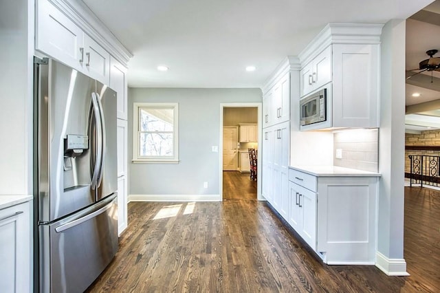 kitchen featuring dark wood finished floors, light countertops, white cabinets, and appliances with stainless steel finishes