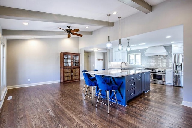 kitchen featuring stainless steel appliances, baseboards, custom exhaust hood, and light countertops