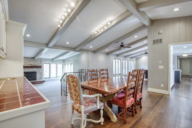 dining space featuring a wealth of natural light, visible vents, wood finished floors, and a ceiling fan