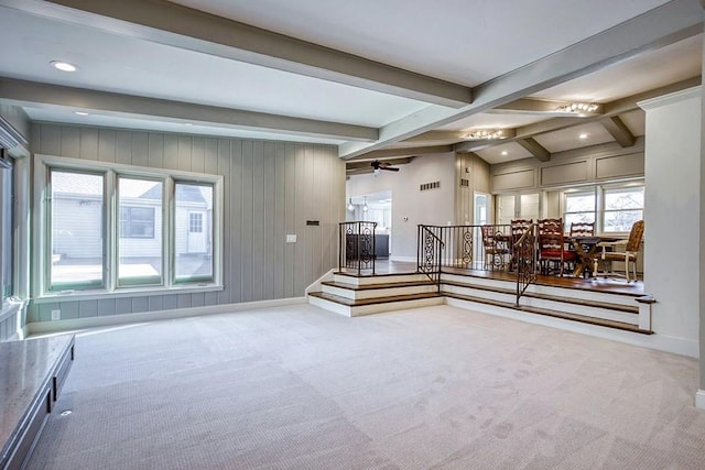 interior space featuring beamed ceiling, carpet flooring, stairway, and a ceiling fan