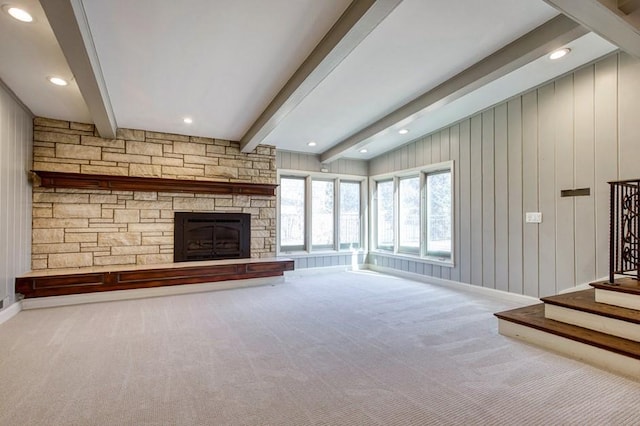 unfurnished living room with beam ceiling, recessed lighting, stairway, carpet floors, and a fireplace