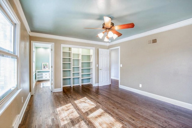 unfurnished bedroom with ornamental molding, wood finished floors, visible vents, and baseboards