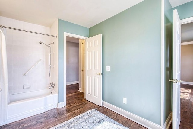 full bathroom with shower / bath combination with curtain, wood finished floors, and baseboards