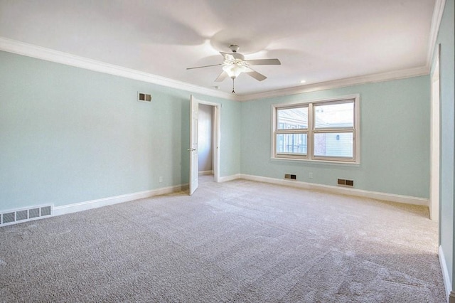 unfurnished room featuring visible vents, crown molding, and ceiling fan