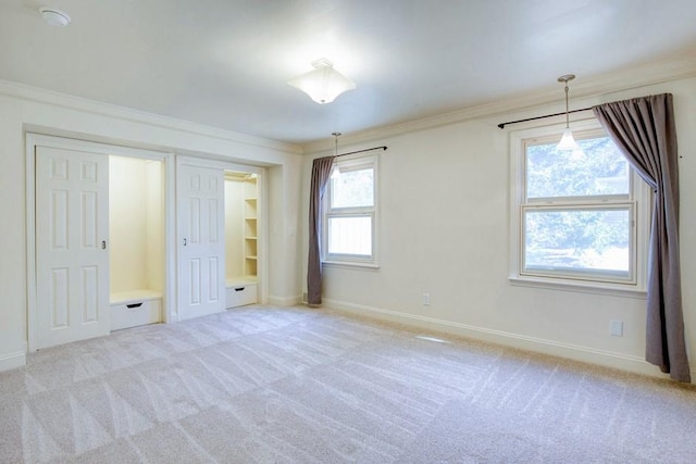 unfurnished bedroom with carpet flooring, crown molding, and baseboards