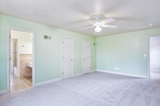 unfurnished bedroom featuring visible vents, baseboards, carpet, and ceiling fan