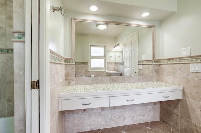 full bath with tile patterned floors, a wainscoted wall, recessed lighting, tile walls, and vanity