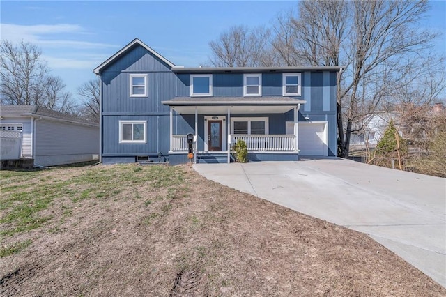 view of front facade featuring covered porch, an attached garage, and driveway