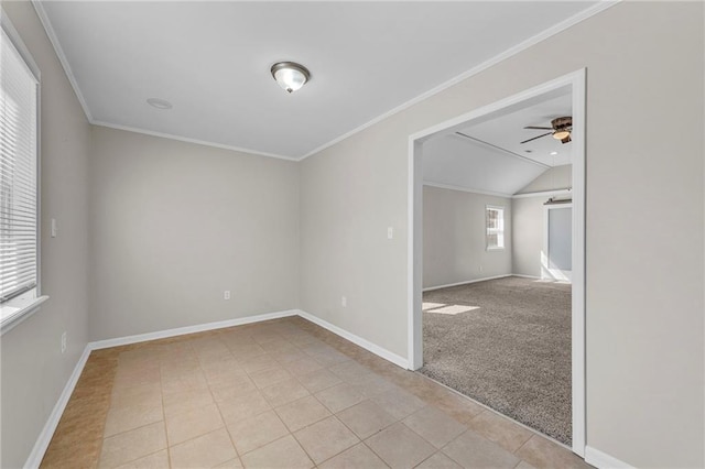 spare room featuring light tile patterned floors, baseboards, a ceiling fan, and crown molding