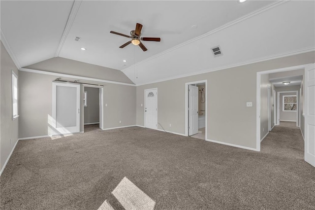 unfurnished bedroom featuring visible vents, carpet floors, baseboards, lofted ceiling, and crown molding