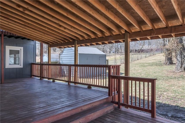 deck featuring a yard, a storage shed, an outdoor structure, and fence