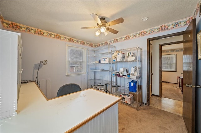 office space featuring light colored carpet, a textured ceiling, and ceiling fan