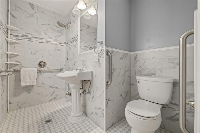 bathroom featuring toilet, tile walls, and a shower stall