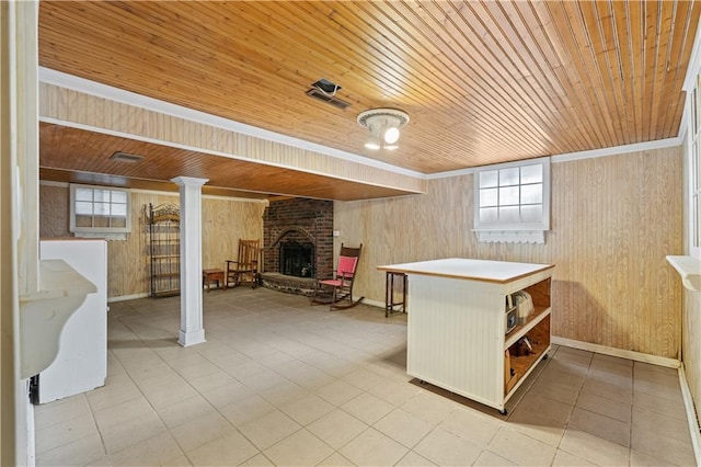 below grade area featuring plenty of natural light, wooden ceiling, a fireplace, and wooden walls