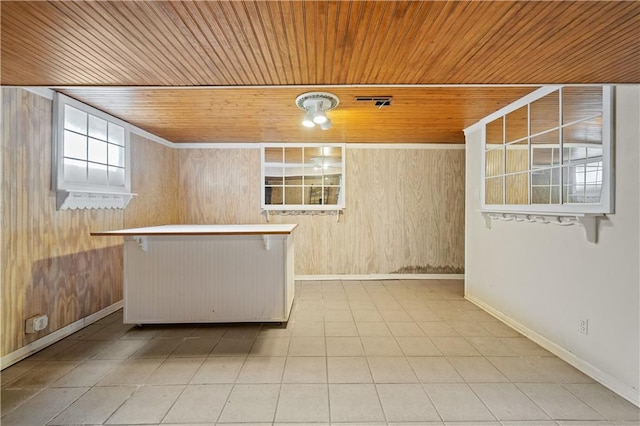 interior space featuring baseboards, wooden walls, wooden ceiling, and tile patterned flooring