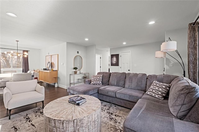 living area with dark wood-style floors, recessed lighting, baseboards, and an inviting chandelier