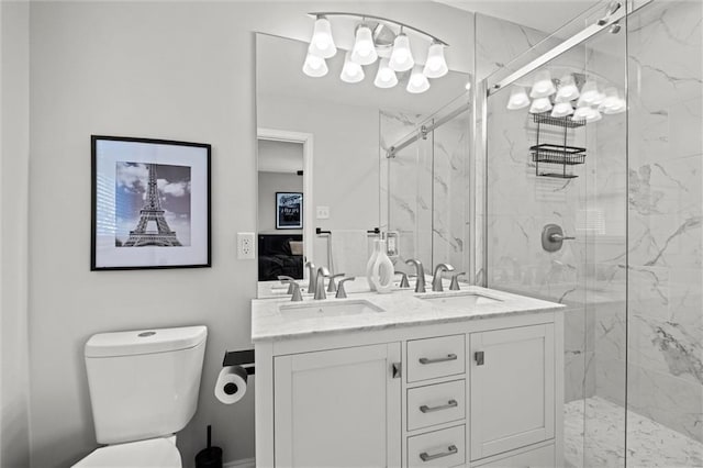 ensuite bathroom featuring double vanity, a marble finish shower, and a sink