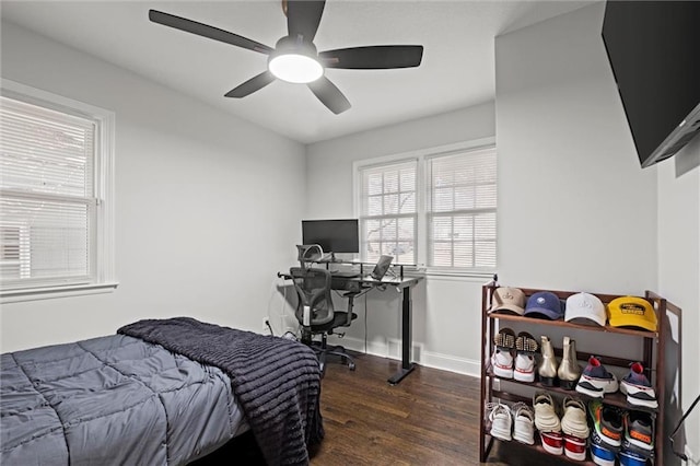 bedroom with ceiling fan, baseboards, and wood finished floors