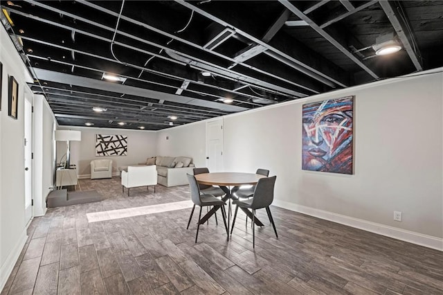 dining area with baseboards and wood finished floors