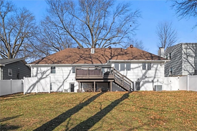 rear view of property with a lawn, a gate, a fenced backyard, stairway, and a wooden deck