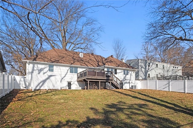 rear view of house with a deck, a fenced backyard, a yard, central AC unit, and stairs