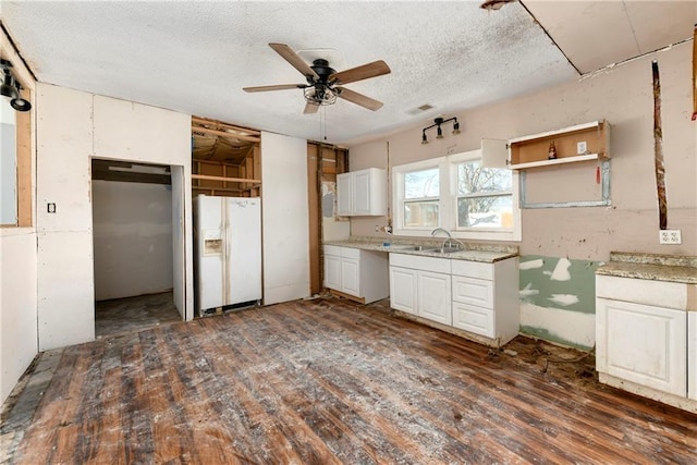 kitchen with a ceiling fan, a sink, white refrigerator with ice dispenser, wood finished floors, and white cabinets