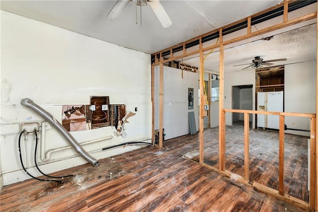 interior space with wood finished floors, electric panel, and a ceiling fan