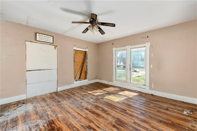 unfurnished room with ceiling fan, baseboards, and wood finished floors