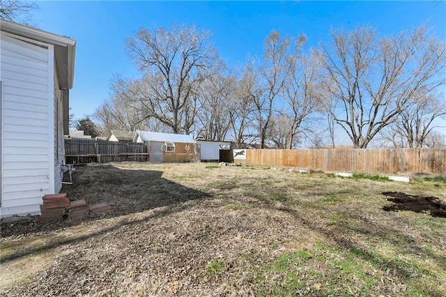 view of yard with an outdoor structure and fence private yard