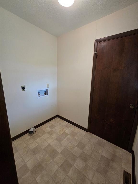 2213 Millwood Dr, Atchison, KS 66002 - laundry room featuring washer hookup, hookup for an electric dryer, light floors, and a textured ceiling