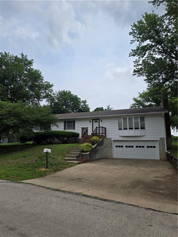 2213 Millwood Dr, Atchison, KS 66002 - view of front facade with an attached garage, driveway, and a chimney