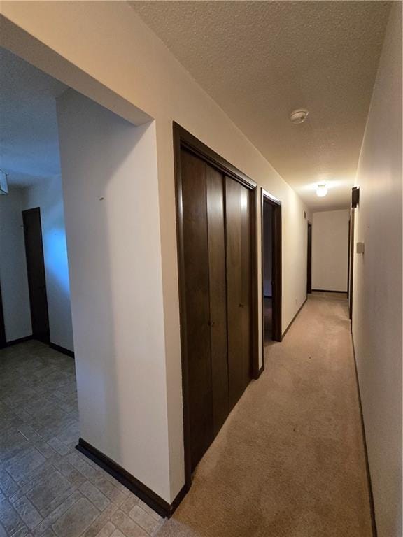 2213 Millwood Dr, Atchison, KS 66002 - hallway featuring baseboards and a textured ceiling