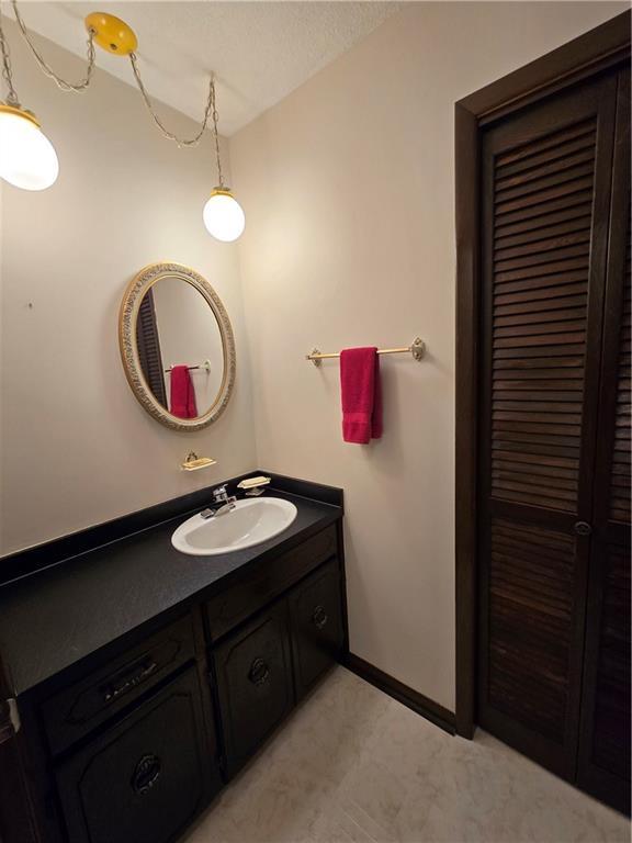 2213 Millwood Dr, Atchison, KS 66002 - bathroom with vanity and baseboards