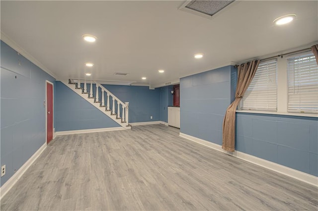 interior space featuring stairway, light wood-style flooring, crown molding, and baseboards