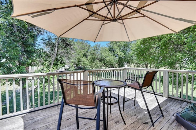 wooden terrace with outdoor dining area