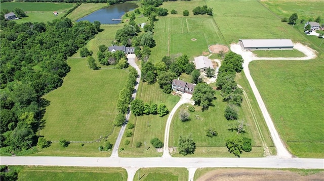 birds eye view of property featuring a water view and a rural view