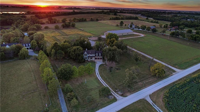 aerial view at dusk featuring a rural view