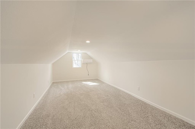 bonus room with lofted ceiling, carpet flooring, and baseboards