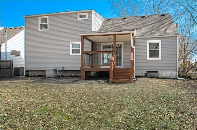 rear view of house featuring central AC unit, a lawn, a deck, and fence