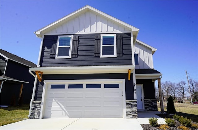 view of front of property with stone siding, an attached garage, board and batten siding, and driveway