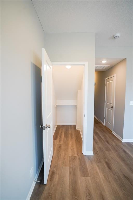 hall with wood finished floors and baseboards