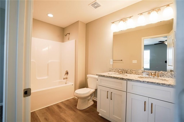 full bath with a sink, visible vents, toilet, and wood finished floors