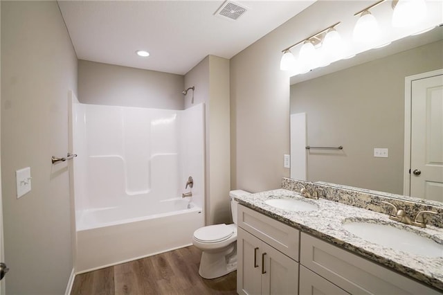 full bathroom with toilet, wood finished floors, visible vents, and a sink