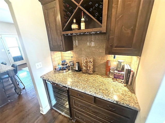 bar with backsplash, baseboards, wine cooler, a dry bar, and dark wood-style floors